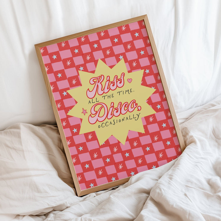 The Kiss All the Time Disco Occasionally print framed on a bed