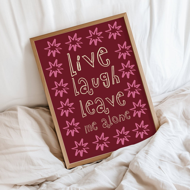 Live Laugh Leave Me Alone quote print displayed in a modern bedroom or home office