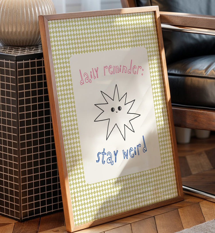 Stay Weird quote print displayed in a contemporary bedroom gallery wall